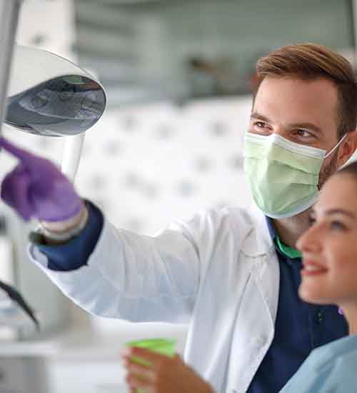 Dentist discussing treatment with a patient.